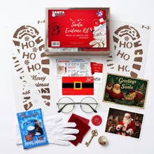 Load image into Gallery viewer, A Santa-themed evidence kit laid out on a white background, including a red Santa Evidence Kit box, white gloves, a red velvet cloth, a small key, a button, a blue snow packet, printed holiday postcard, and stencil-style cutout sheets.
